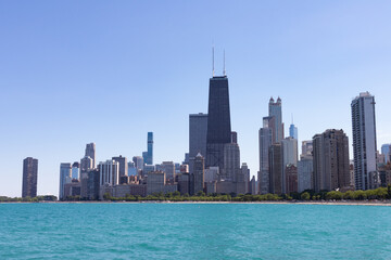Fototapeta na wymiar Chicago Skyline along Lake Michigan during the Summer with a Clear Blue Sky