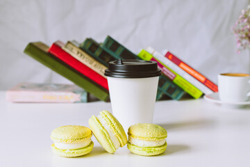 set of macaroons with flowers and coffee cup in cafe