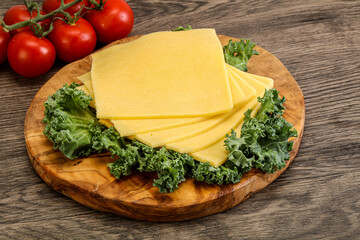 Sliced Gauda cheese over board