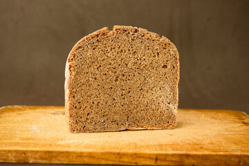 Piece of rye bread on a wooden board