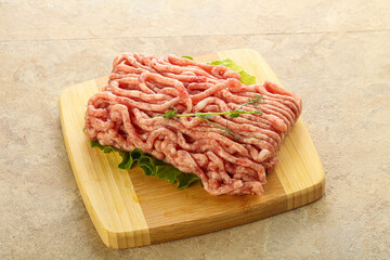 Raw minced pork meat over board