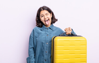 pretty young woman with cheerful and rebellious attitude, joking and sticking tongue out. travel...