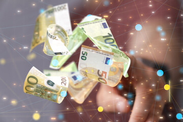 euro bills flying around  in hand