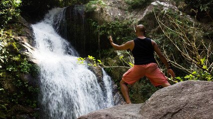 person near waterfall, thailand