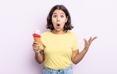 pretty young woman amazed, shocked and astonished with an unbelievable surprise. ice cream concept