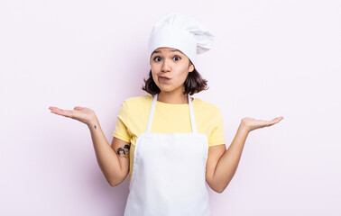 pretty young woman feeling puzzled and confused and doubting. chef concept