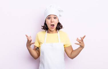 pretty young woman amazed, shocked and astonished with an unbelievable surprise. chef concept