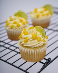 Lime cupcake with white cream on a marble background	