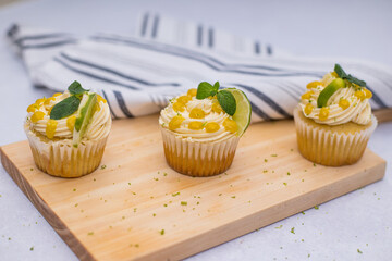 lime cupcakes on a wooden table with a cloth