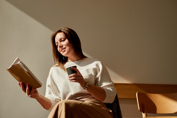 Woman with coffee reading book