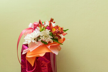 A small bouquet of flowers in a festive package.