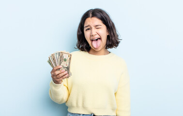 pretty young woman with cheerful and rebellious attitude, joking and sticking tongue out. dollar...