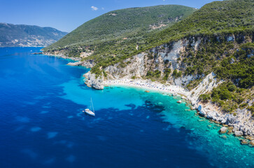 Fototapeta na wymiar Aerial drone photo of iconic paradise sandy beach of Agiofili near port of Vasiliki with emerald crystal clear sea and sail boats docked, Lefkada island, Ionian, Greece