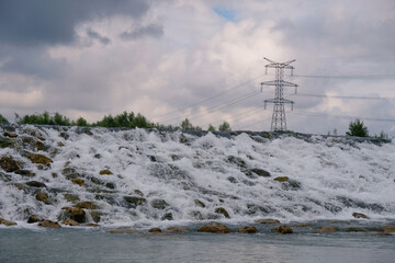 Durance mountain river in Avignon Provence France. Power lines along the river.