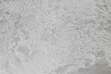Gray-white background with a gray accent on the edges. The texture of decorative plaster. Copy space