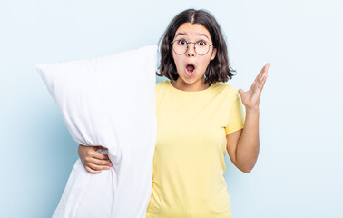 pretty young woman amazed, shocked and astonished with an unbelievable surprise. bed concept