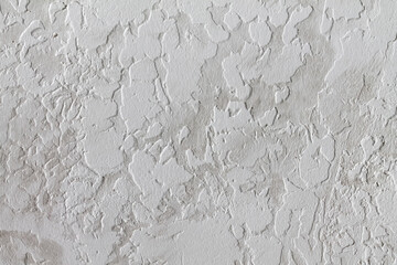 Gray-white background. The texture of decorative plaster.