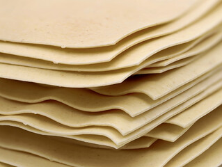 close up of uncooked stacked lasagne sheets isolated on white background - Powered by Adobe