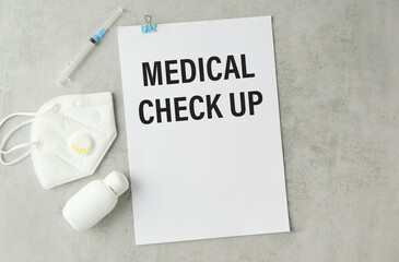 Card with text Medical check up , pills and stethoscope.