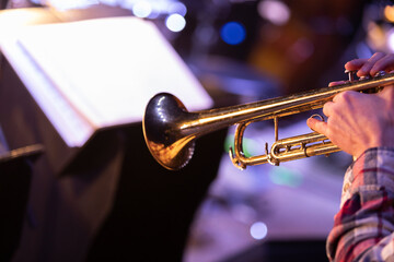 A person playing the trumpet in a big band