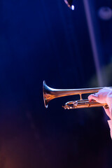 Part of a trumpet on a dark blue and purple background