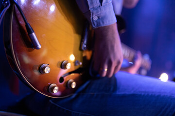 A person playing an electric guitar in a big band