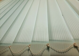 Light vertical stripes of closed blinds