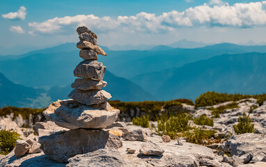 Beautiful alpine summer view with a cairn and mountains in the background at the famous Loser...