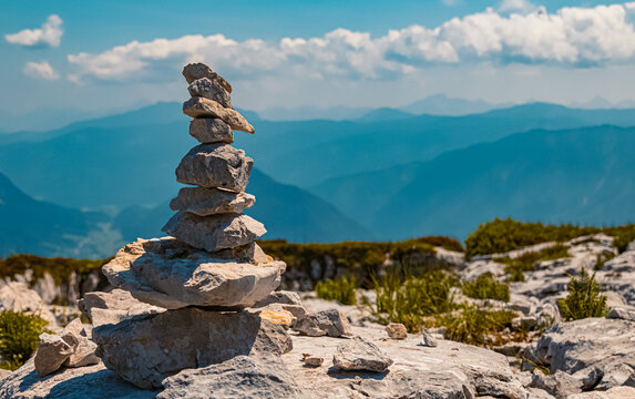 Beautiful alpine summer view with a cairn and mountains in the background at the famous Loser summit, Altaussee, Steiermark, Austria
