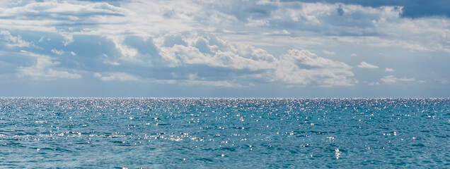 blue sea horizon sparkling in the rays of the morning banner
