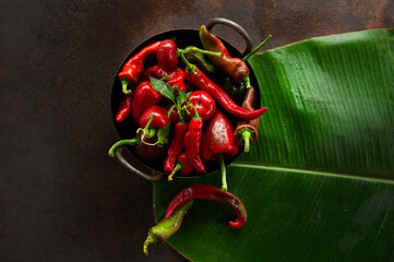 Red pepper on banana leaf  - obrazy, fototapety, plakaty
