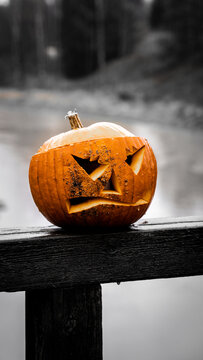 Angry carved halloween pumpkin on the bridge. 