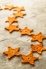 Christmas garland with knitted yellow stars. Handmade Christmas décor.