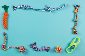 Colorful cotton rope toys for cat puppy dog on light blue background. Top view, copy space