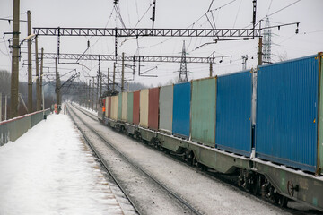 Fototapeta premium The container train transports goods in the winter. In perspective. Logistic concept.