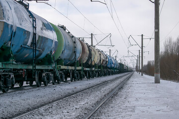 Fototapeta na wymiar Transportation of liquid bulk cargoes by rail in winter. In perspective. Logistic concept.