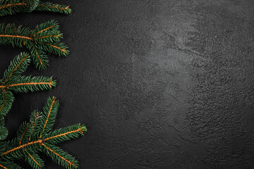 Christmas fir tree branches frame on dark background. Flat lay, top view, copy space. Christmas and New Year holiday background.