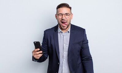 young handsome man with cheerful and rebellious attitude, joking and sticking tongue out business...