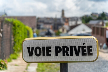 Signboard in Honfleur with the french sign Voie privee - private road in english translation