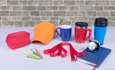 Composition of different promo products with rich colors -Thermo mugs, Lanyards Neck Strap, pens,...