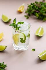 Summer  lemonade, cocktails of citrus infused water or mojitos, with lime, lemon , ice and mint, diet detox beverages, in glasses 