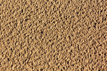 The surface of coarse sand after rain. Close-up. Selective focus
