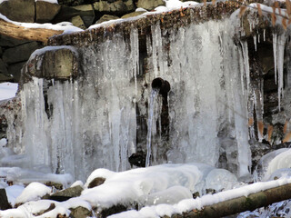 Winter - frozen waterfall with lots of icicles