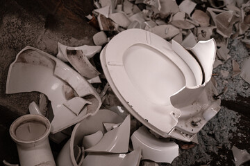 Broken toilet in a garbage container - 465369341