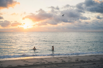 Men in the ocean during sunrise