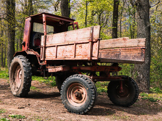 Old rusty tractor in the forest.
