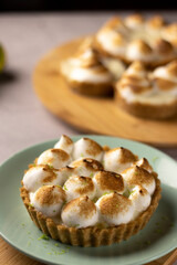 Lemon Meringue fresh pie on green plate