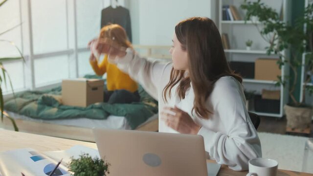 Tired Girl Student Studying, Preparing for the Exam, Arguing with her Roommate in College. Learning Problems During Isolation. Concept of Fatigue and Modern Learning Online. Mental Health.