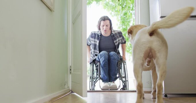 Happy caucasian disabled man in wheelchair entering his house with his dog