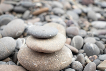 Fototapeta na wymiar cairn of stones by the sea